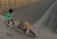 an Indian boy working at a brick kiln on the outskirts of Jalandhar. Brick kiln workers in India are trapped in a cycle of bonded labour and regularly cheated out of promised wages, Anti-Slavery International said September 20, urging the government to safeguard their rights | Shammi Mehra/AFP